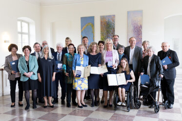 Gruppenbild aller ausgezeichneten Personen der Bayerischen Staatsmedaille für soziale Verdienste mit Staatsministerin Ulrike Scharf.